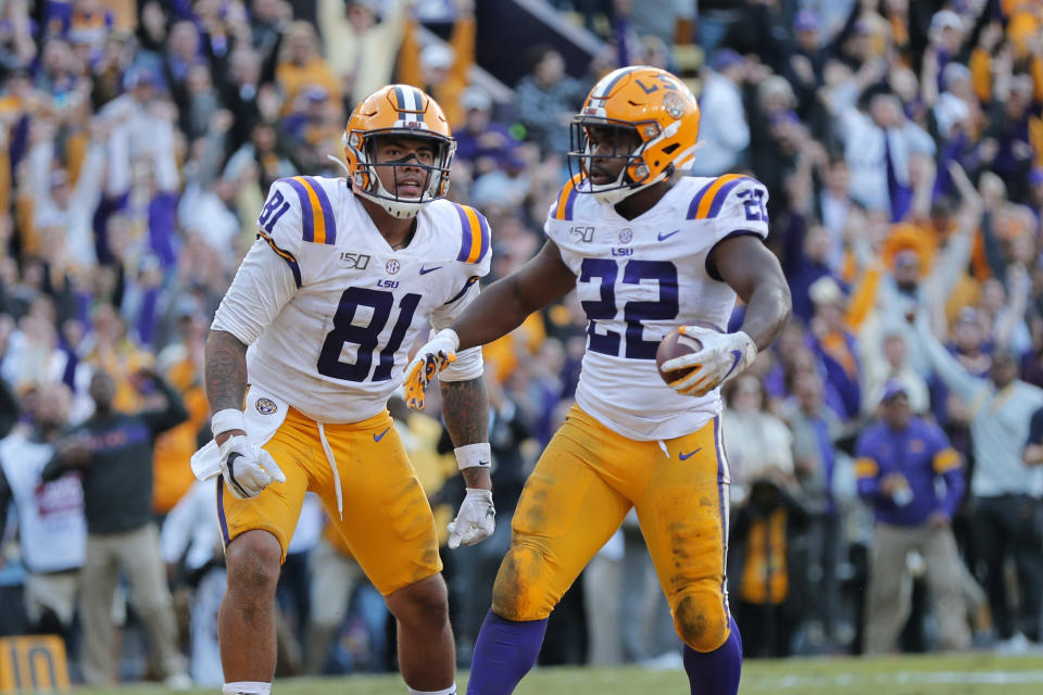 LSU running back Clyde Edwards-Helaire (22) celebrates his touchdown with tight end Thaddeus Moss (81) in the second half of an NCAA college football game against Auburn in Baton Rouge, La., Saturday, Oct. 26, 2019. LSU won 23-20. (AP Photo/Gerald Herbert)