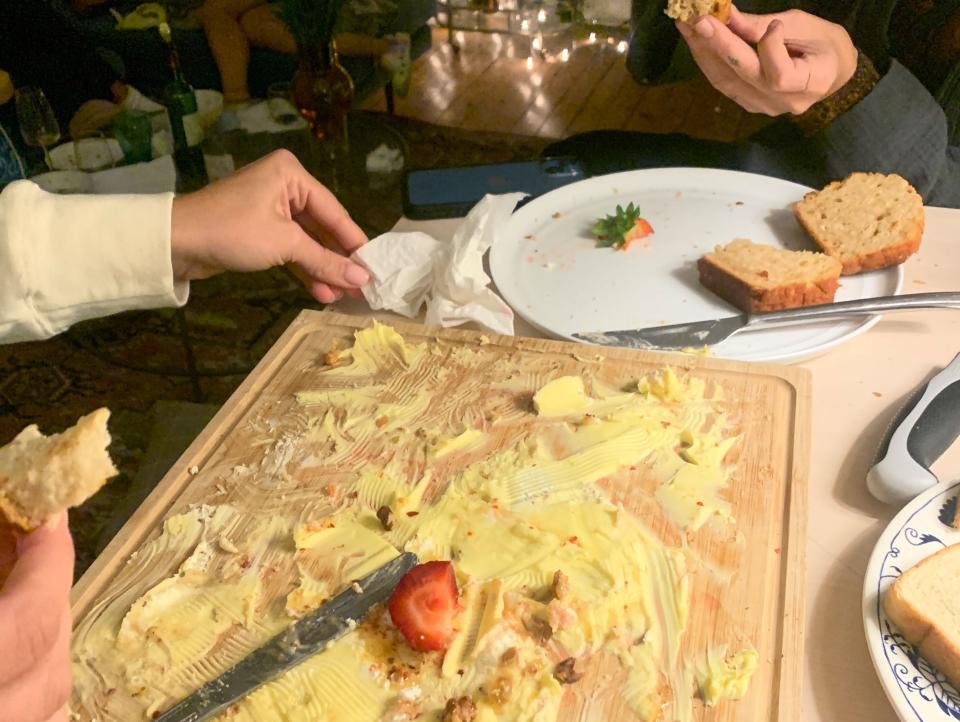 the aftermath: a cutting board with one strawberry and little butter left