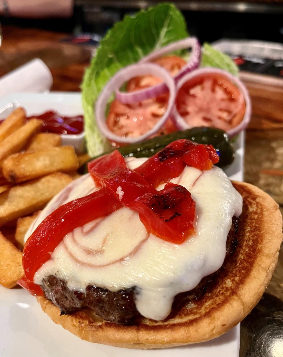 The Burger Caprese at Zino Neighborhood Restaurant is juicy, flavorful joy on a toasted bun.