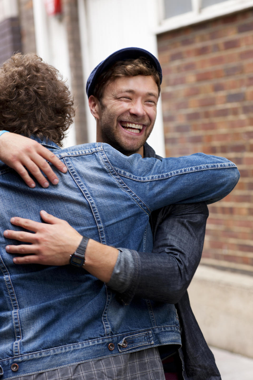 a man hugging another person