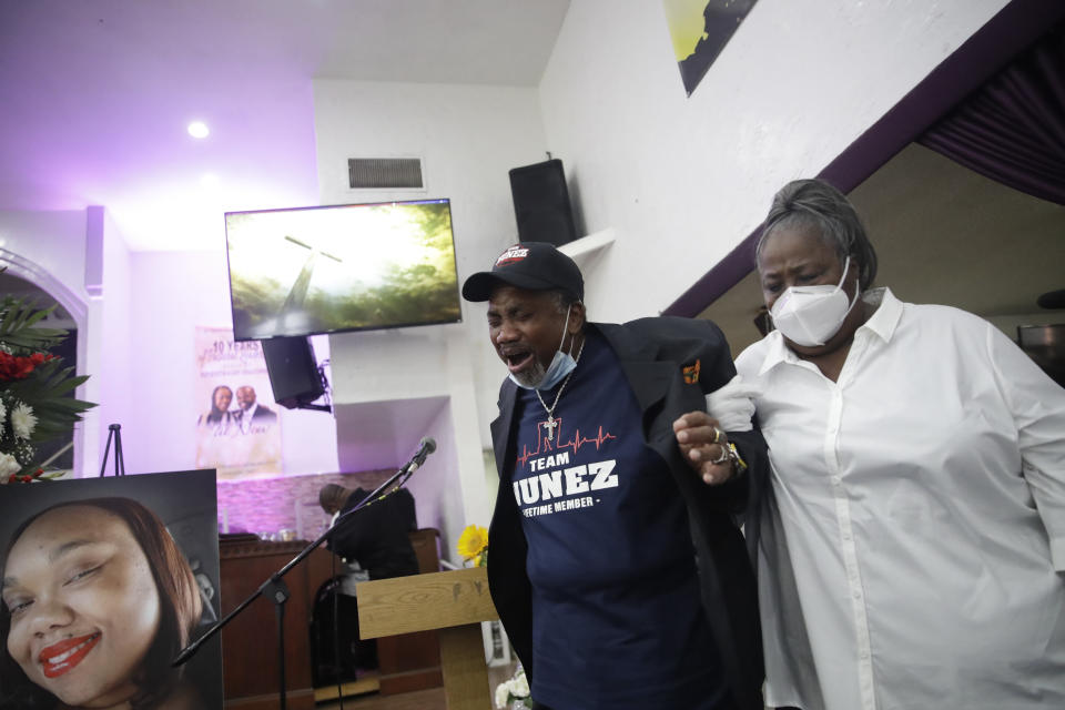 Samuel Nunez, center, cries as he walks past a picture of his daughter Lydia Nunez, bottom left, who died of COVID-19, during a funeral service at the Metropolitan Baptist Church Tuesday, July 21, 2020, in Los Angeles. (AP Photo/Marcio Jose Sanchez)