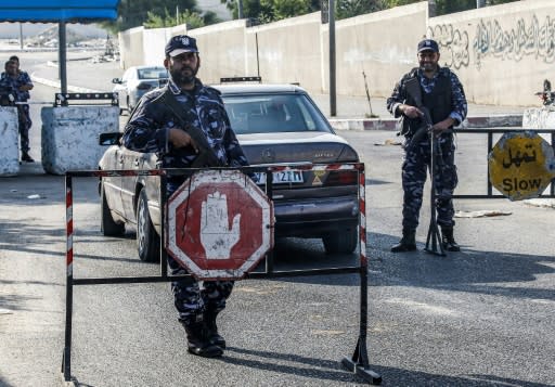 Security forces loyal to Palestinian Islamist movement Hamas man a checkpoint and stop vehicles in Khan Yunis in the southern Gaza Strip on Wednesday after two explosions overnight