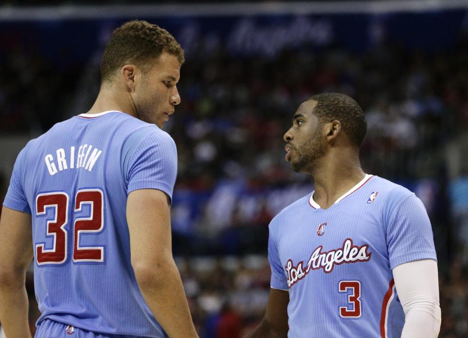 Los Angeles Clippers's Blake Griffin, left, talks with Chris Paul during the first half of an NBA basketball game on Sunday, March 16, 2014, in Los Angeles. (AP Photo/Jae C. Hong)