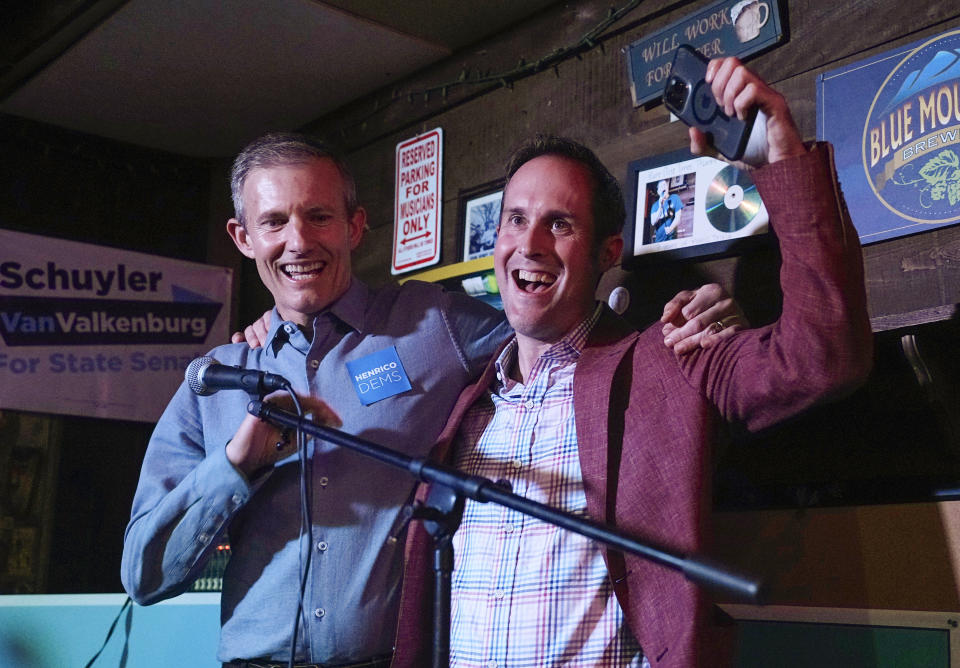 Democrats Del. Schuyler VanValkenburg, right, and Del. Rodney Willett celebrate at an election party Tuesday Nov. 7, 2023, in Richmond, Va. (AP Photo/Steve Helber)