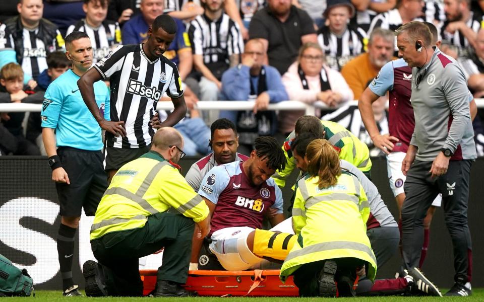 Aston Villa's Tyrone Mings appears in pain after picking up an injury during the Premier League match at St. James' Park