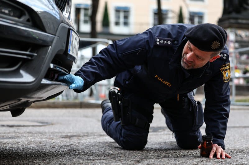 A German police officer checks a car for explosives in front of the Bayerischer Hof hotel, venue for the 60th Munich Security Conference in the southern German state of Bavaria, as world leaders meet amid a slew of pressing concerns from Ukraine and Gaza to worries over the future of NATO should Donald Trump win the U.S. presidency in November. Photo by Anna Szilagyi/EPA/EFE