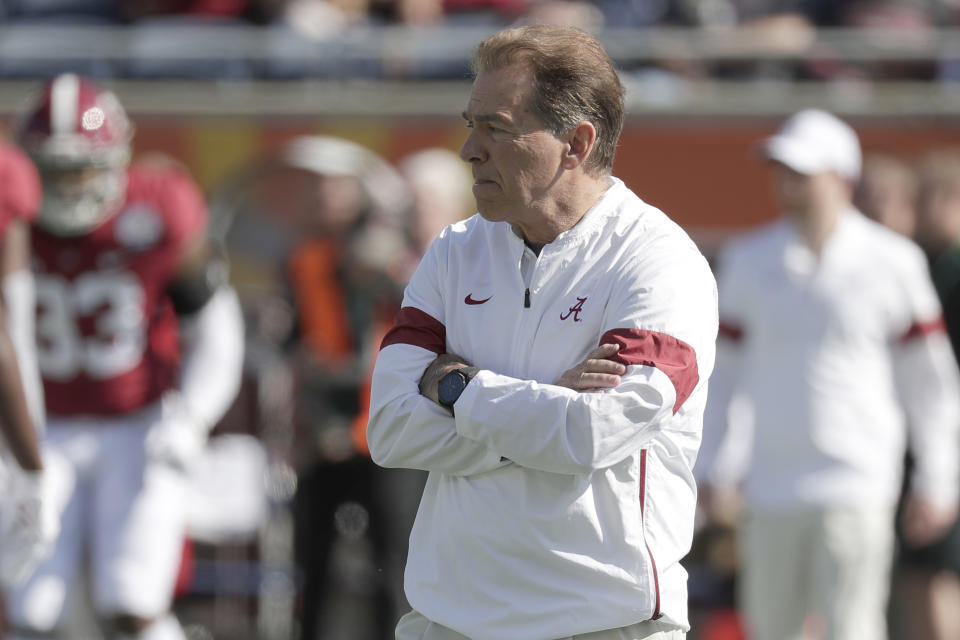 Alabama head coach Nick Saban watches players warm up before the Citrus Bowl NCAA college football game, Wednesday, Jan. 1, 2020, in Orlando, Fla. (AP Photo/John Raoux)