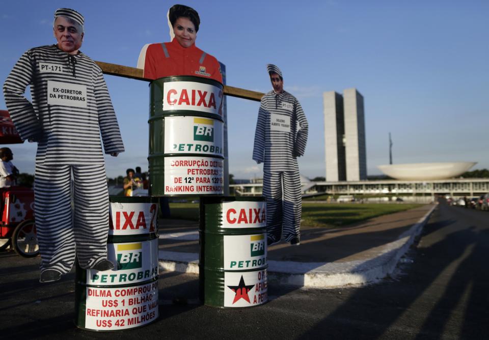 Cardboard cut-out of Brazil's President Dilma Rousseff is seen on top of a barrel in front of the National Congress in Brasilia