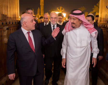 Saudi Arabia's King Salman bin Abdulaziz Al Saud welcomes Iraqi Prime Minister Haider Al-Abadi in Riyadh, Saudi Arabia October 21, 2017. Bandar Algaloud/Courtesy of Saudi Royal Court/Handout via REUTERS ATTENTION EDITORS - THIS PICTURE WAS PROVIDED BY A THIRD PARTY.