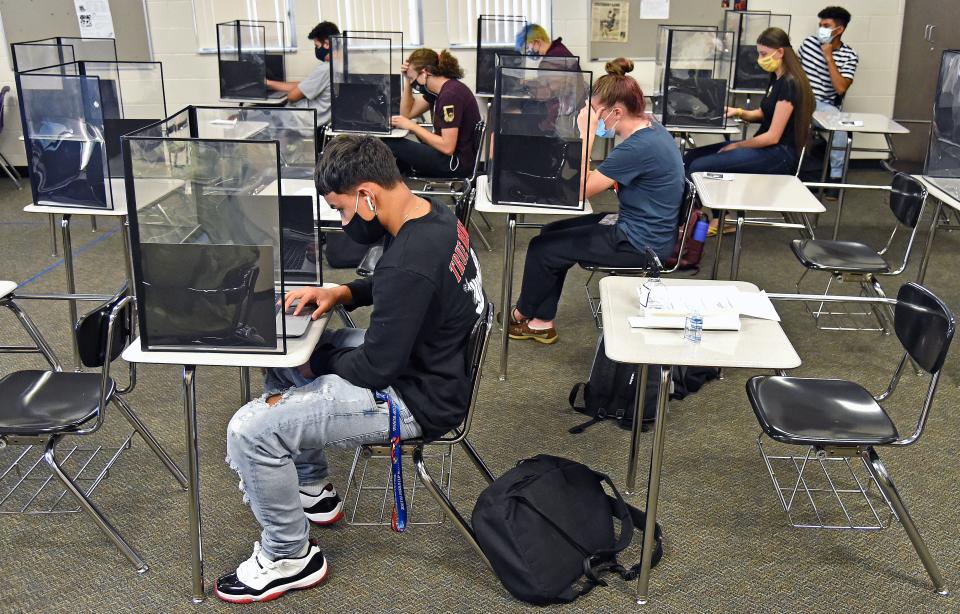 Booker High School students in Sarasota, Fla., work in a classroom set up for social distancing.