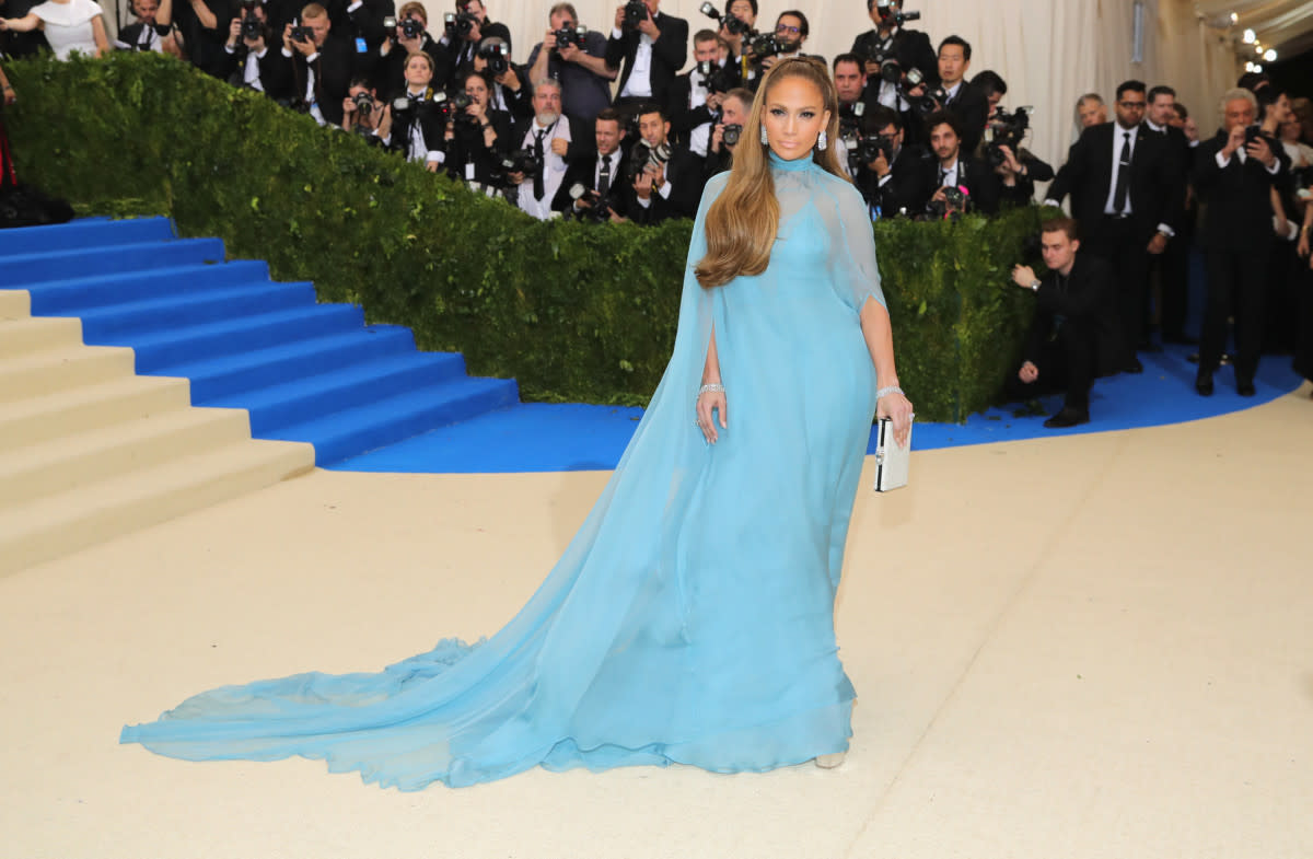 <p>Neilson Barnard/Getty Images</p><p>Jennifer Lopez felt blue in a flowing Versace gown, complete with sheer cape, at the <a href="https://parade.com/567668/paulettecohn/photos-the-best-from-the-2017-met-gala-red-carpet/" rel="nofollow noopener" target="_blank" data-ylk="slk:2017 Met Gala;elm:context_link;itc:0;sec:content-canvas" class="link rapid-noclick-resp">2017 Met Gala</a>, themed “Rei Kawakubo/Comme des Garcons: Art Of The In-Between."</p>