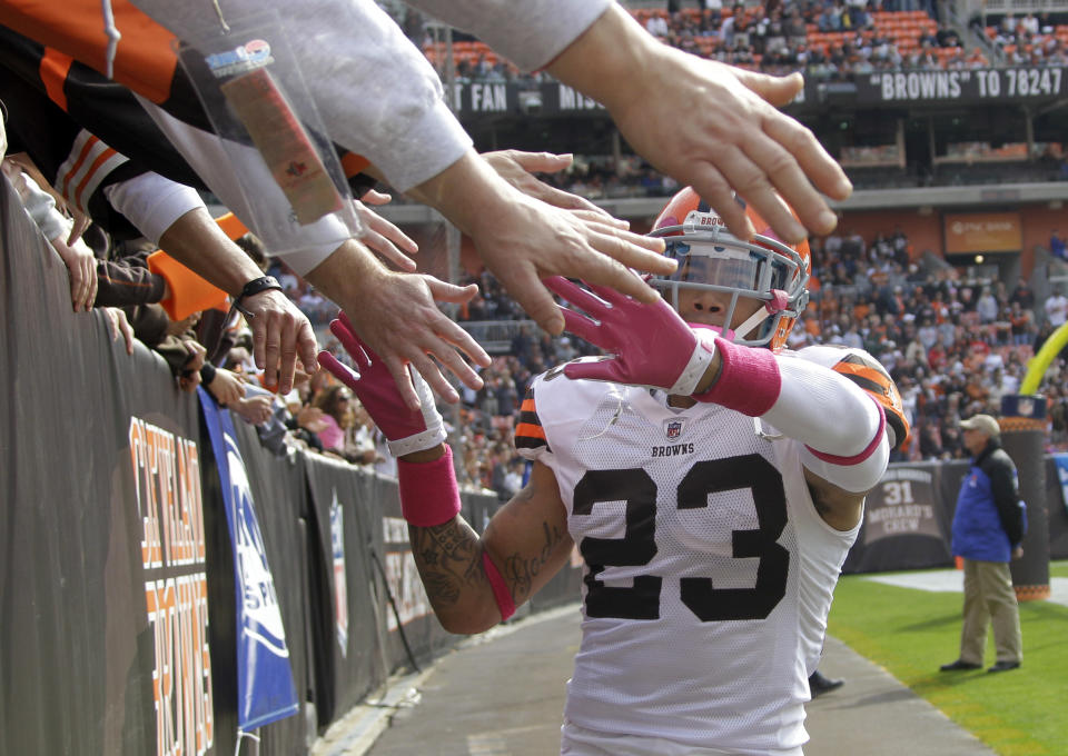 FILE - In this Oct. 23, 2011, file photo, Cleveland Browns' cornerback Joe Haden greets fans in the Dawg Pound before an NFL football game against the Seattle Seahawks, in Cleveland. As lock-downs are lifted, restrictions on social gatherings eased and life begins to resemble some sense, sports are finally starting to emerge from the coronavirus pandemic. When stadiums do reopen for fans, how are teams going to drive them through the gate?(AP Photo/Mark Duncan, File)