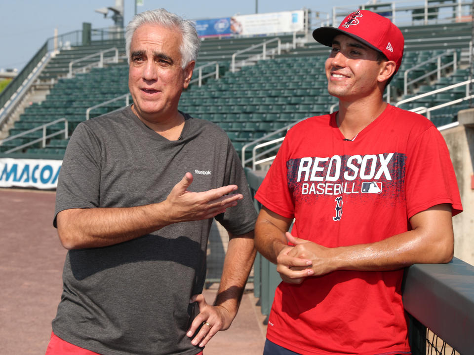 LOWELL, MA - JULY 2: ESPN's Pedro Gomez, left, stands with his son Rio Gomez, a rookie pitcher with the Lowell Spinners, before a game against the Aberdeen Tigers at LeLacheur Park in Lowell, MA on July 2, 2018. The elder Gomez has covered baseball in Bristol, CT since 2003, regularly appearing on shows such as SportsCenter and Baseball Tonight.  The younger Gomez was selected by the Red Sox in the 36th round of the 2017 MLB Draft.  (Photo by Matthew J. Lee/The Boston Globe via Getty Images)