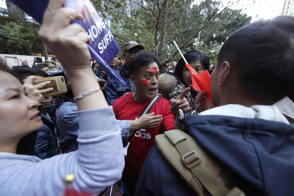 A pro-Beijing supporter yells at a photographer during a rally in Hong Kong on Saturday, Dec. 7, 2019. Six months of unrest have tipped Hong Kong's already weak economy into recession. (AP Photo/Mark Schiefelbein)