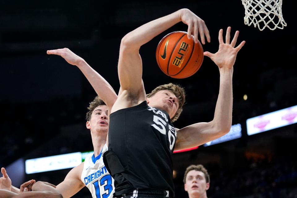 Xavier forward Gytis Nemeiksa (50) fights for a rebound with Creighton forward Mason Miller (13) during the first half of an NCAA college basketball game, Tuesday, Jan. 23, 2024, in Omaha, Neb.