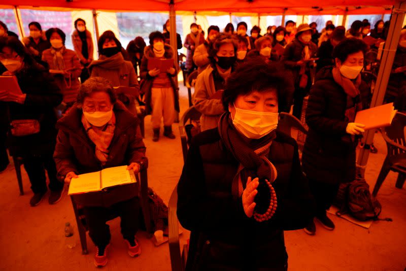 Buddhist believers pray for their children’s success in the college entrance examinations amid the coronavirus disease (COVID-19) pandemic, at a Buddhist temple in Seoul