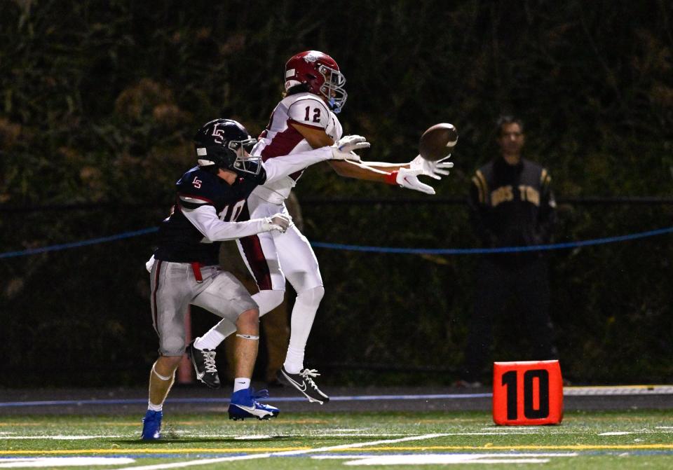 Charlie Barringer of Lincoln-Sudbury plays close defense as Jaden Lopes Ribeiro of Brockton makes a completion during a football game at Lincoln-Sudbury High School, Friday, Sept. 22, 2023. Lincoln-Sudbury defeated Brocton 29-21 in overtime.