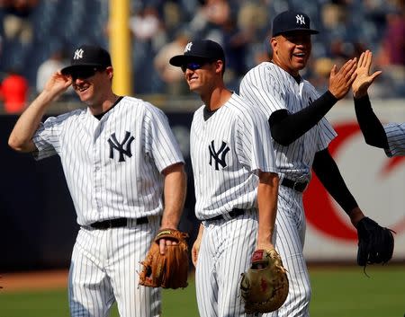 Aug 19, 2015; Bronx, NY, USA; New York Yankees third baseman Chase Headley (12), New York Yankees first baseman Greg Bird (31) and New York Yankees relief pitcher Dellin Betances (68) react after defeating the Minnesota Twins 4-3 at Yankee Stadium. Mandatory Credit: Noah K. Murray-USA TODAY Sports