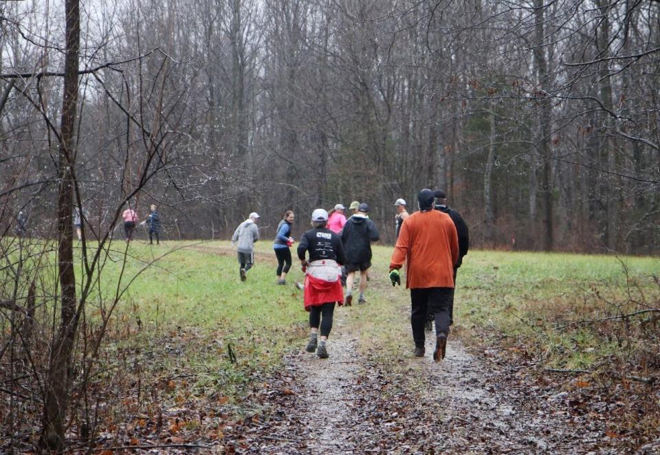 Walking and running along trails through woods and fields are participants in the 2022 First Day Trail Run at Fairfax State Recreation Area.