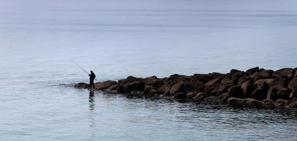 <p>A man enjoys fishing in the fine weather near Folkestone in Kent. Picture date: Monday April 19, 2021.</p>
