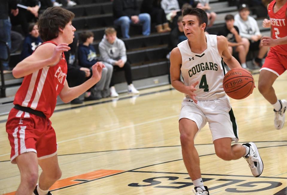 North Star's CJ Biery (4) drives the center of the lane against Everett's Nicholas Hartman, left, during the opening game of the Pine Grill Roundball Classic, Dec. 2, in Somerset.