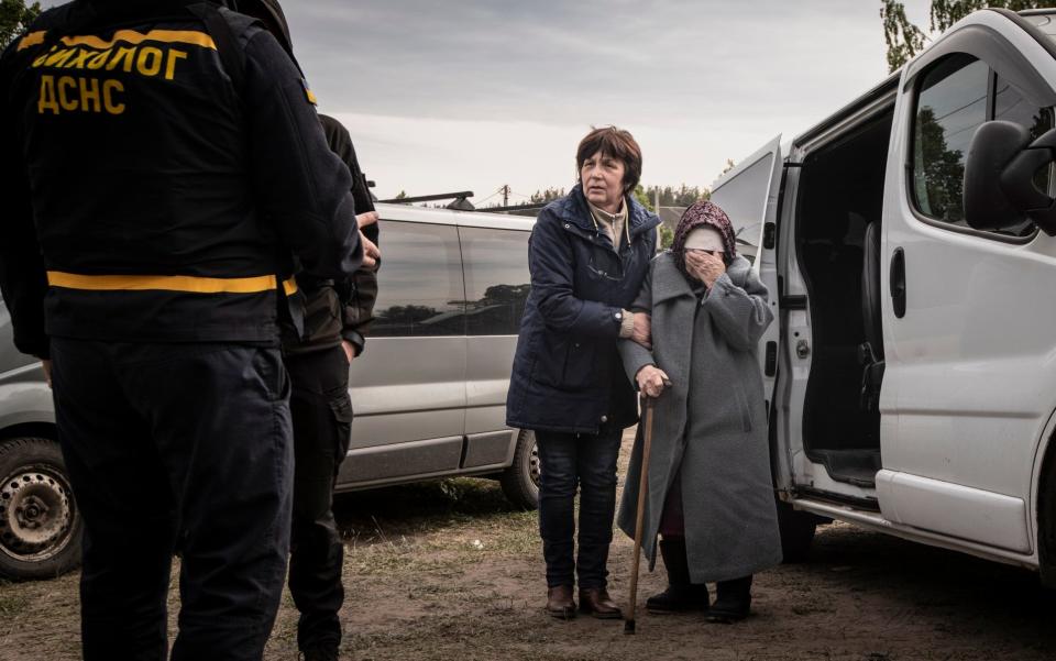 Residents arrive at the village of Buhaivka after the evacuation of the town of Vovchansk in the Kharkiv region