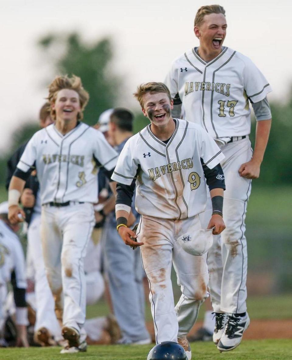 Maize South’s Seth Davis (3), Bradyn Wlens (9) Griffin Stadler (17) celebrate after defeating Bishop Carroll 2-1 in the 5A regional championship at Maize South Wednesday. (May 18, 2016)