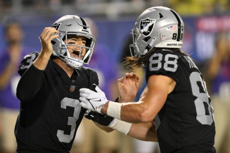 Las Vegas Raiders quarterback Jarrett Stidham (3) celebrates with tight end Jacob Hollister (88) after Stidham scrambled for a touchdown during the first half of the team's NFL football exhibition Hall of Fame Game against the Jacksonville Jaguars, Thursday, Aug. 4, 2022, in Canton, Ohio. (AP Photo/David Richard)