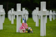 <p>French and U.S. flags near the graves of fallen soldiers at the Normandy American Cemetery, which contains the remains of 9,387 American military dead, most killed during the invasion of Normandy and ensuing military operations in World War II. (Photo: Artur Widak/NurPhoto via Getty Images) </p>