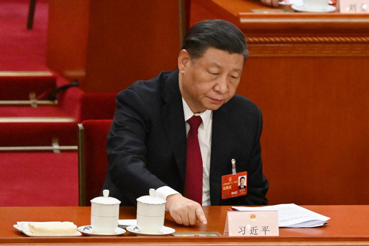 File: Xi Jinping votes during the closing session of the National People’s Congress at the Great Hall of the People in Beijing on 13 March 2023 (AFP via Getty Images)