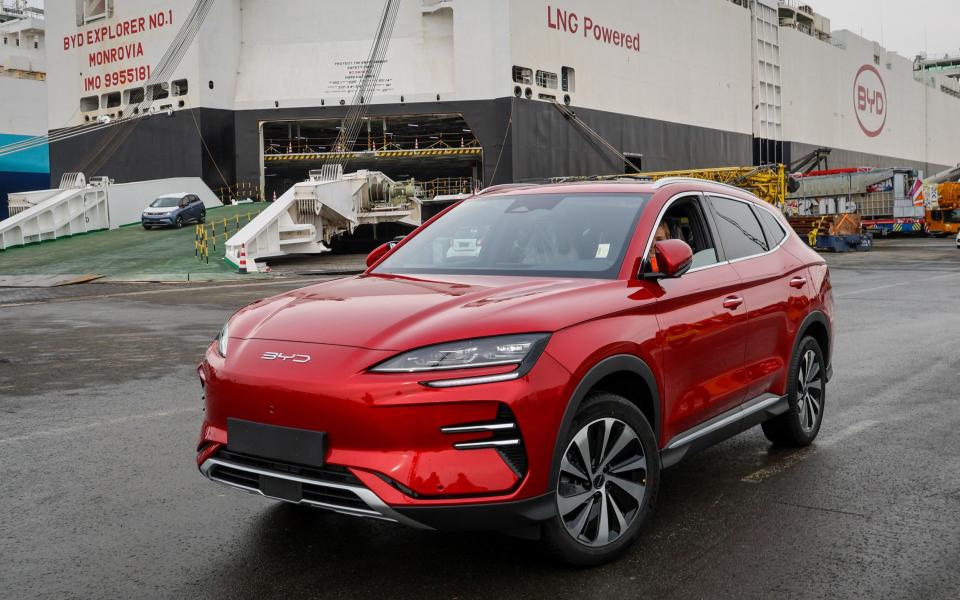 A car from BYD stands in front of the carrier ship BYD Explorer No 1, moored at  Bremerhaven, Germany, today