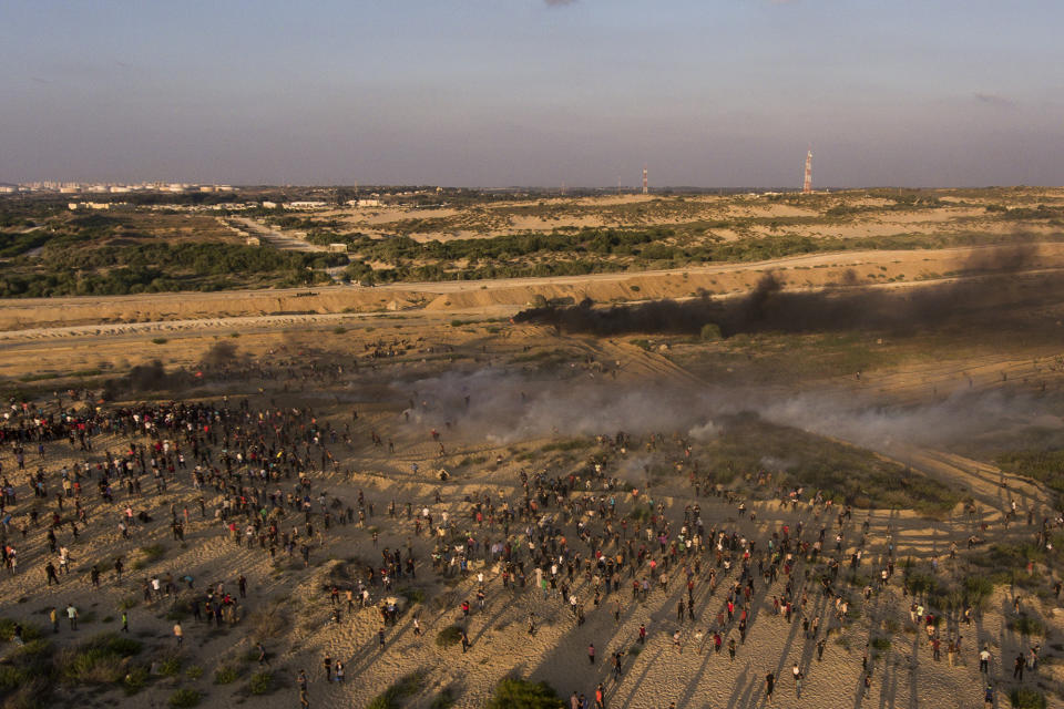 Aerial view of protesters running from teargas fired by Israeli soldiers during a protest on the beach at the border with Israel near Beit Lahiya, northern Gaza Strip, Monday, Sept. 17, 2018. (AP Photo/Felipe Dana)