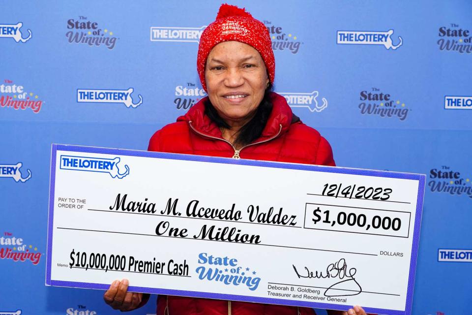 <p>Courtesy of Massachusetts State Lottery</p> Maria Acevedo Valdez with her lottery winnings.