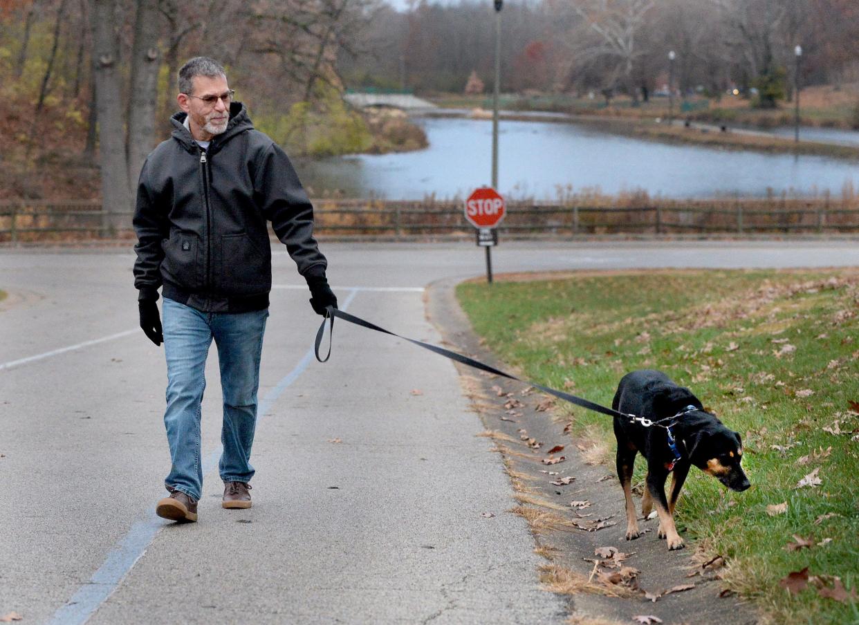Matt Costa of Springfield walks his dog Crescent, a seven year-old mixed breed, At Washington Park Monday, Nov. 20, 2023.