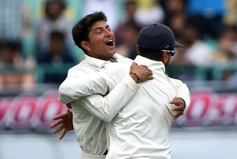 India's Kuldeep Yadav (L) celebrates the wicket of Australia's Peter Handscomb with teammate Murali Vijay during the fourth Test at The Himachal Pradesh Cricket Association Stadium in Dharamsala on March 25, 2017