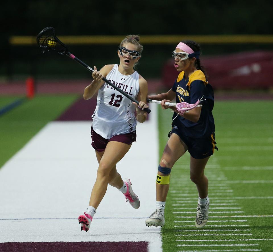 Highland's Caitlin Becker covers an O'Neill player during the Section 9 Class D girls lacrosse final on May 24, 2023.