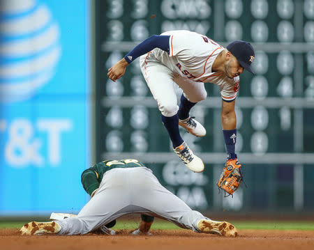 FILE PHOTO: Aug 28, 2018; Houston, TX, USA; Oakland Athletics center fielder Ramon Laureano (22) is safe at second base with a stolen base as Houston Astros shortstop Carlos Correa (1) attempts to apply a tag during the fourth inning at Minute Maid Park. Mandatory Credit: Troy Taormina-USA TODAY Sports