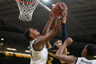 Iowa forward Keegan Murray, left, fights for a rebound with Michigan guard DeVante' Jones (12) during the second half of an NCAA college basketball game, Thursday, Feb. 17, 2022, in Iowa City, Iowa. (AP Photo/Charlie Neibergall)