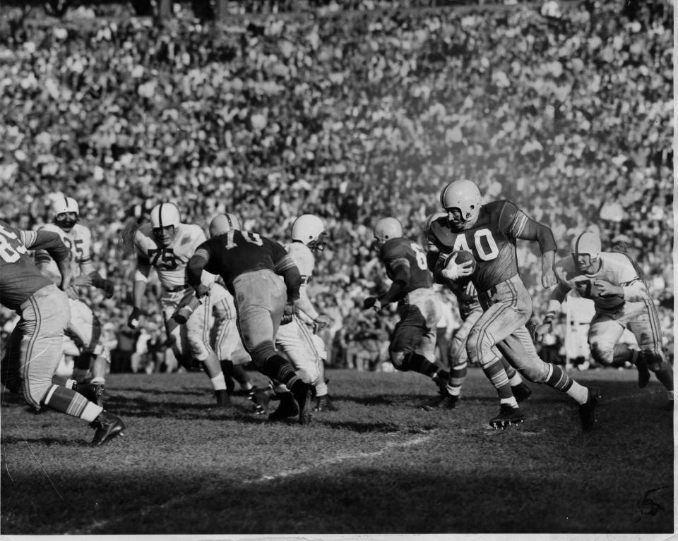 Howard "Hopalong" Cassady of fourth-ranked Ohio State heads 88 yards to the end zone after intercepting a Wisconsin pass in 1954, turning the tide against the No. 2 Badgers and perhaps saving Woody Hayes' job as coach.