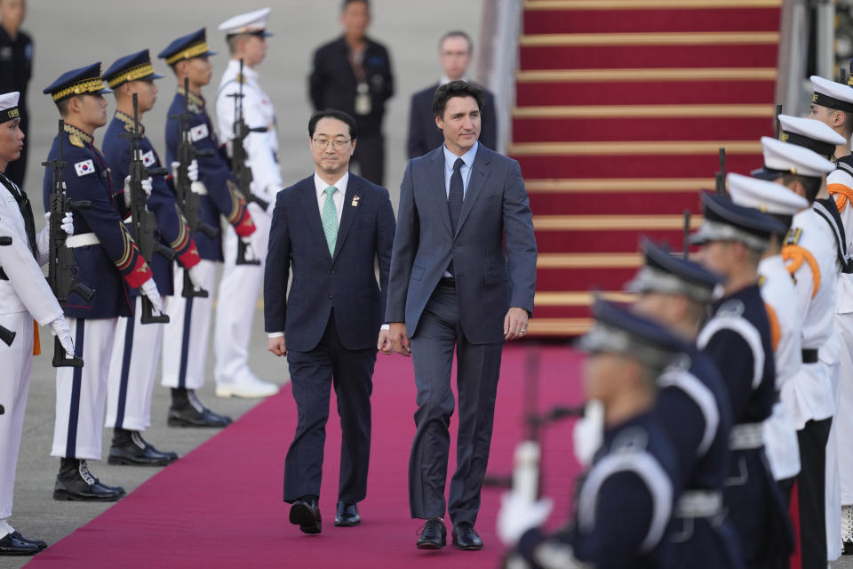 Canadian Prime Minister Justin Trudeau, right, is escorted by South Korea's Special Representative for Korean Peninsula Peace and Security Affairs Kim Gunn, left, upon his arrival at the Seoul airport in Seongnam, South Korea, Tuesday, May 16, 2023. Trudeau arrived Tuesday in South Korea and will meet with South Korean President Yoon Suk Yeol, before heading to Japan for a G7 summit. (AP Photo/Lee Jin-man)