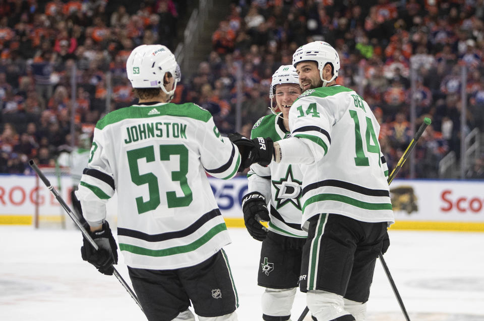 Dallas Stars' Wyatt Johnston (53), Jamie Benn (14) and Ty Dellandrea (10) celebrate after a goal against the Edmonton Oilers during third-period NHL hockey game action in Edmonton, Alberta, Saturday, Nov. 5, 2022. (Jason Franson/The Canadian Press via AP)