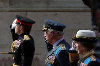 <p>Britain's King Charles III (C) and Britain's Princess Anne, Princess Royal salute as they pass the Cenotpah war memorial as they walk behind the coffin of Queen Elizabeth II, during a procession from Buckingham Palace to the Palace of Westminster, in London on September 14, 2022. ADRIAN DENNIS/Pool via REUTERS</p> 