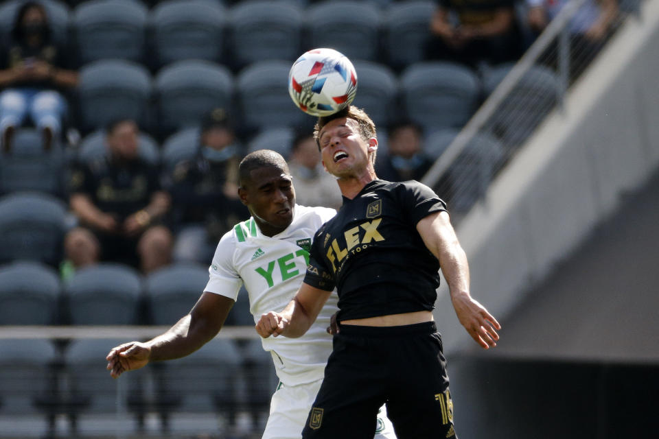 Los Angeles FC forward Danny Musovski, right, heads the ball next to Austin FC defender Jhohan Romana during the first half of an MLS soccer match Saturday, April 17, 2021, in Los Angeles. (AP Photo/Ringo H.W. Chiu)