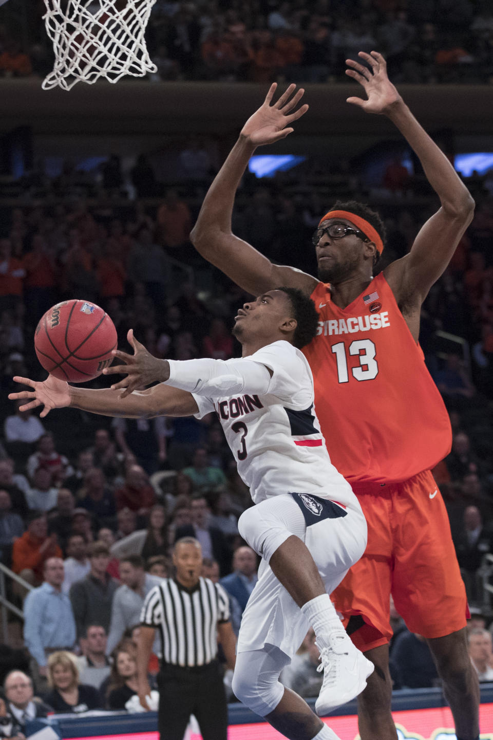 Connecticut guard Alterique Gilbert (3) goes to the basket against Syracuse center Paschal Chukwu (13) during the second half of an NCAA college basketball game in the 2K Empire Classic, Thursday, Nov. 15, 2018, at Madison Square Garden in New York. Connecticut won 83-76. (AP Photo/Mary Altaffer)