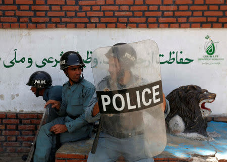 Afghan policemen keep watch during a demonstration by Afghanistan's Hazara minority in Kabul, Afghanistan July 23, 2016. REUTERS/Mohammad Ismail