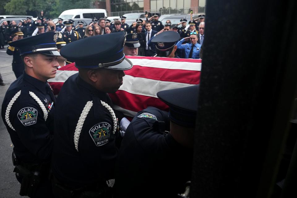 An Austin police honor guard carries fallen officer Jorge Pastore's flag-draped casket to the armored SWAT vehicle leading the procession Nov. 17 at a Weed-Corley-Fish Funeral Homes location in Austin. Pastore, 38, was killed by a gunman Nov. 11.