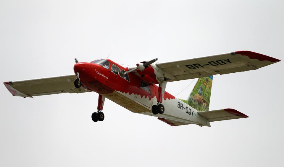 A Britten-Norman BN-2 Islander aircraft, operated by Trans Guyana Airways, flies over the National Stadium in Georgetown, Guyana on May 13, 2011.
