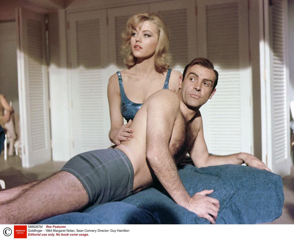 <p>Sean Connery with Margaret Nolan in ‘Goldfinger’</p>Rex Features