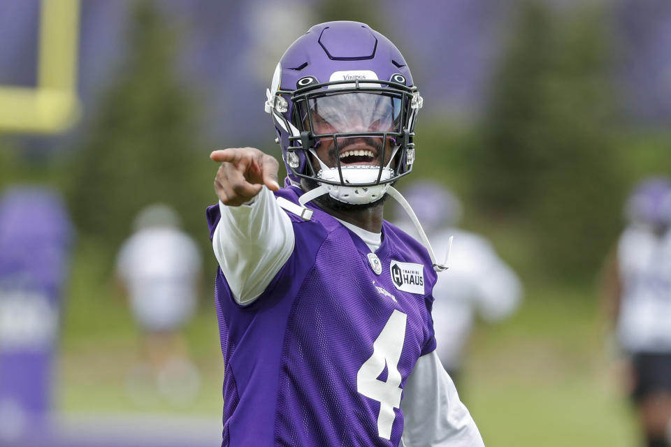 Minnesota Vikings running back Dalvin Cook laughs with his teammates as they take part in drills at the NFL football team's practice facility in Eagan, Minn., Tuesday, May 17, 2022. (AP Photo/Bruce Kluckhohn)