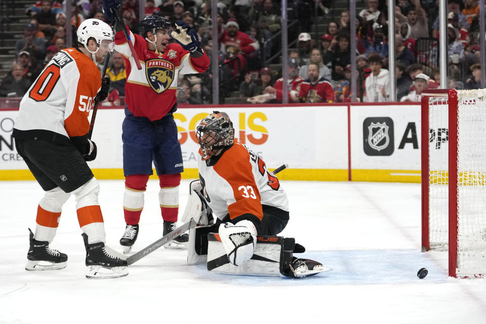 Florida Panthers center Evan Rodrigues, center, reacts as the puck gets past Philadelphia Flyers goaltender Samuel Ersson (33) on a goal scored by Florida Panthers defenseman Gustav Forsling, not shown, during the second period of an NHL hockey game, Thursday, March 7, 2024, in Sunrise, Fla. (AP Photo/Lynne Sladky)